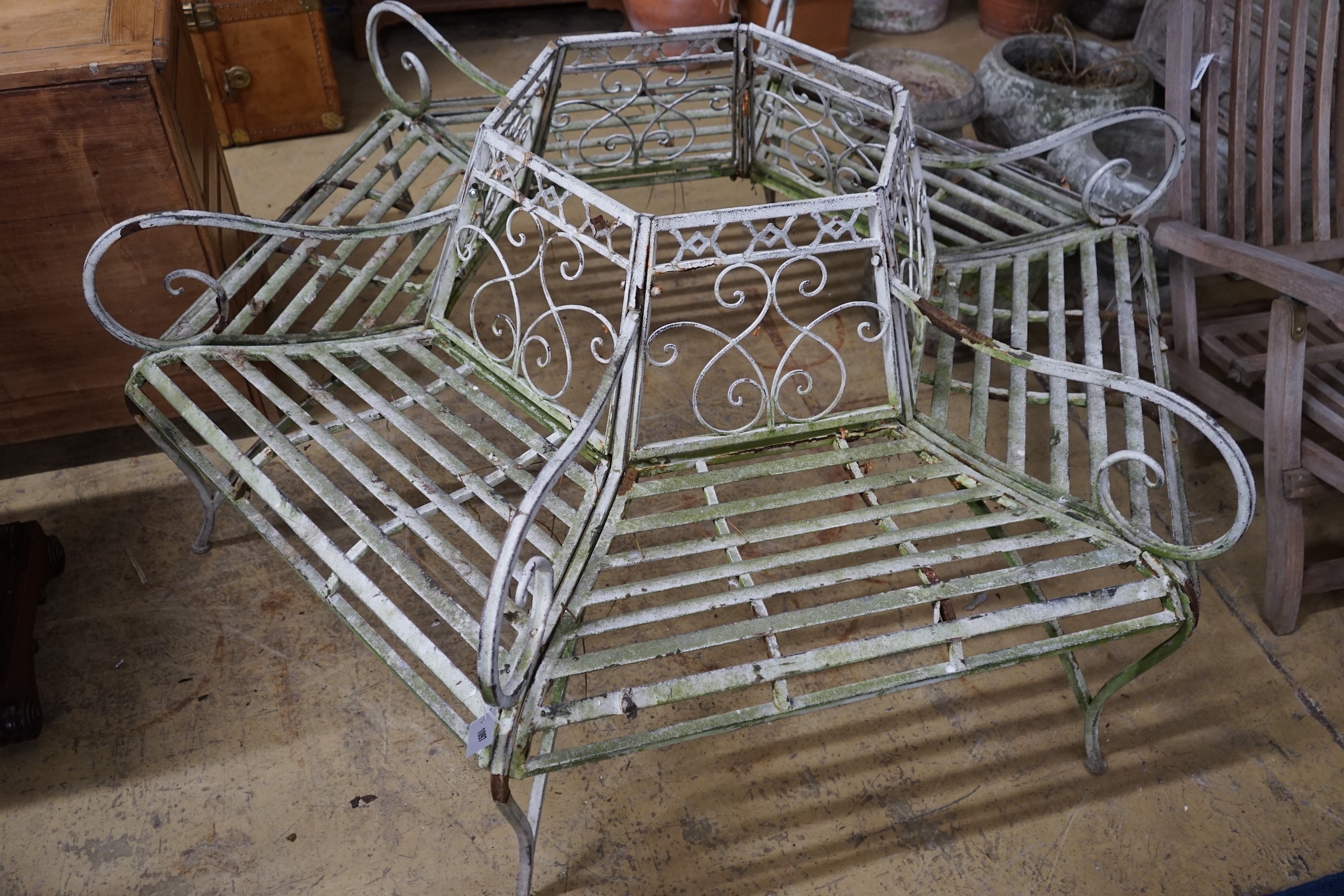 A painted wrought iron hexgonal tree seat, length 150cm, height 77cm